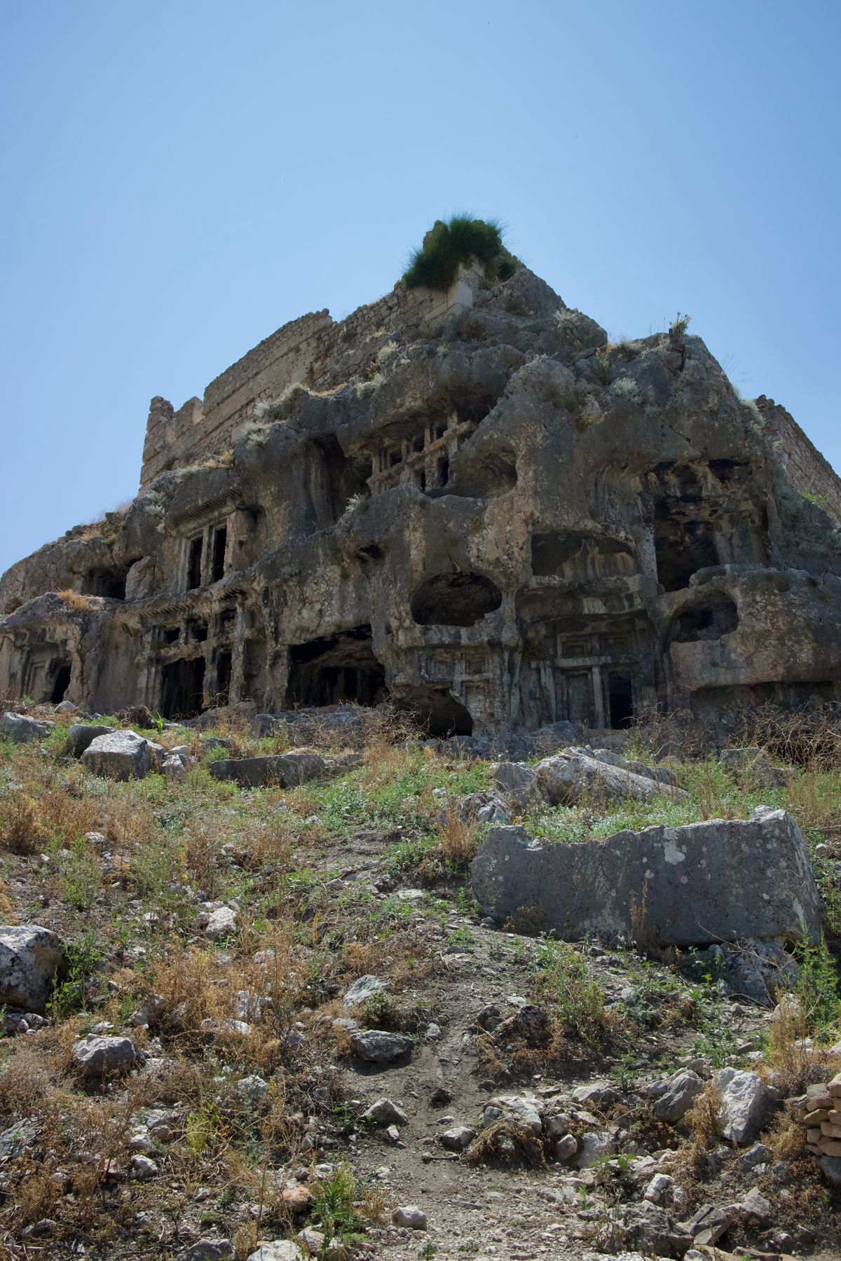 The acropolis crag at Tlos with ruined fortress walls above the valley